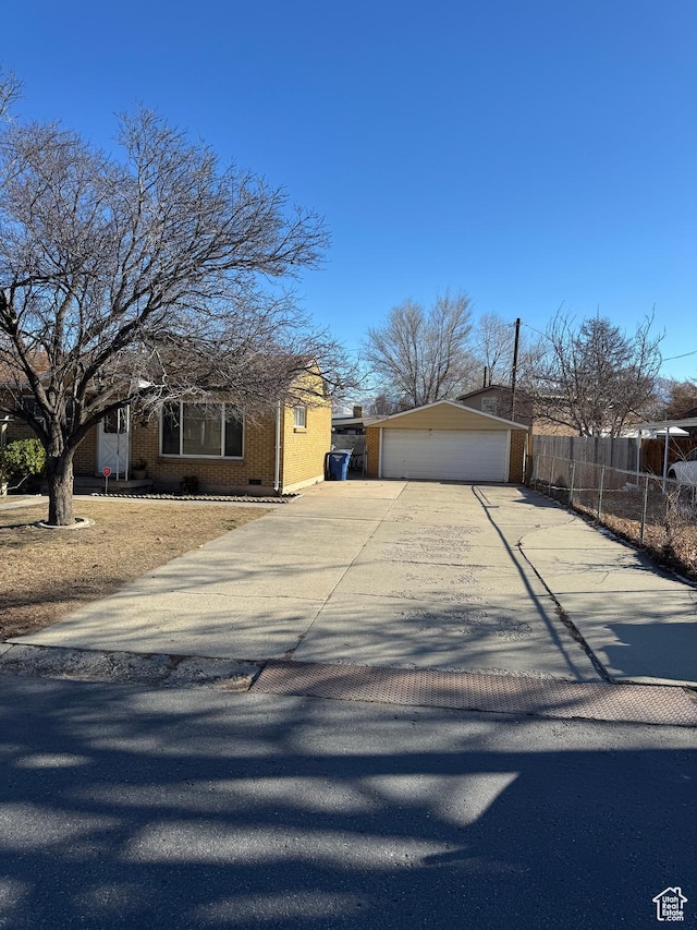 3375 S Meadowlark Dr, West Valley City, UT 84119 - view of front of property featuring a detached garage, an outbuilding, brick siding, and concrete driveway