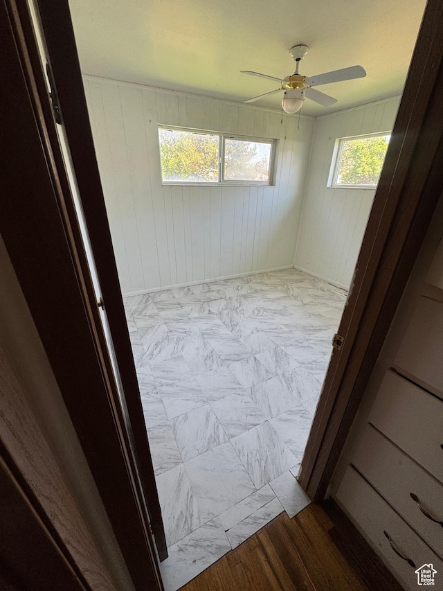 3375 S Meadowlark Dr, West Valley City, UT 84119 - spare room featuring ceiling fan and wooden walls