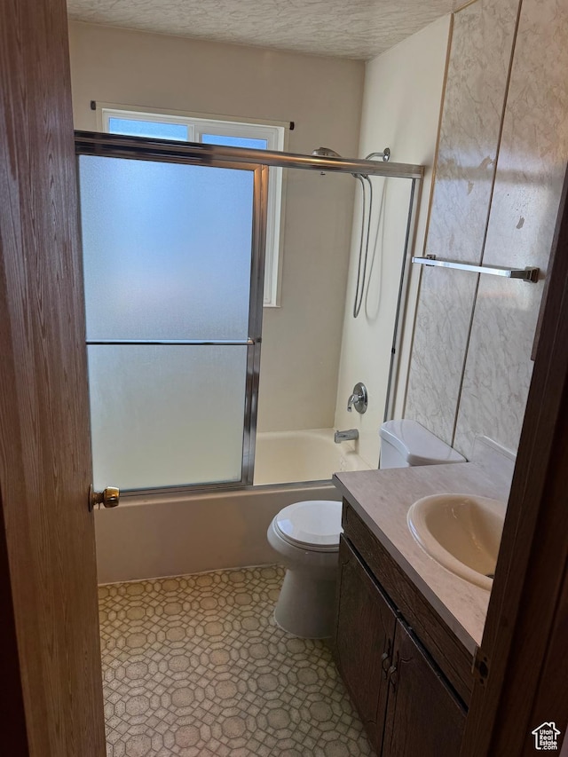 3375 S Meadowlark Dr, West Valley City, UT 84119 - full bathroom featuring vanity, toilet, combined bath / shower with glass door, and a textured ceiling