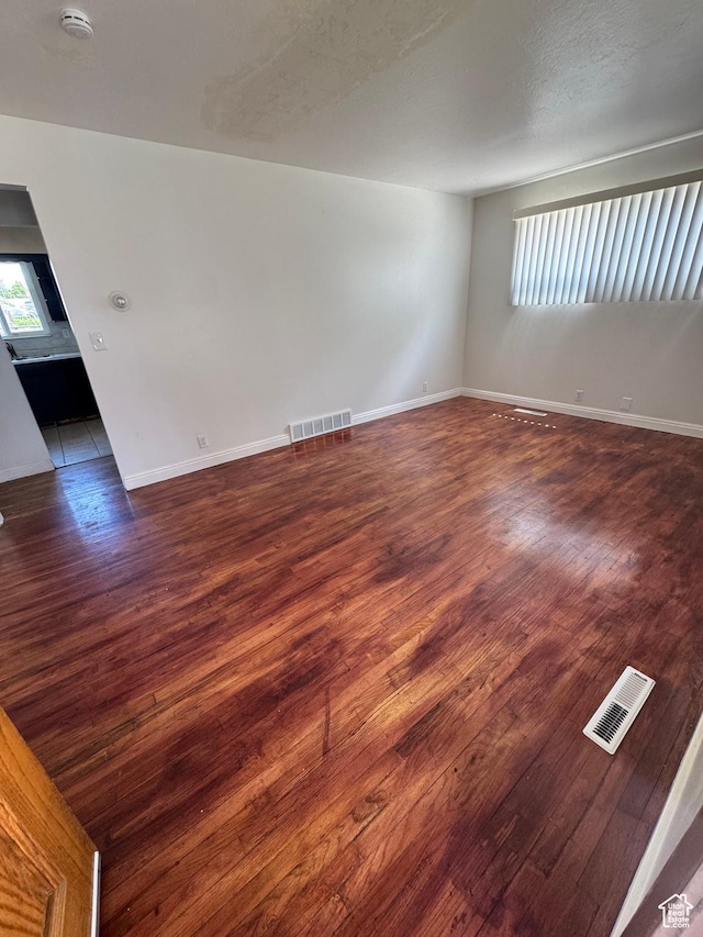 3375 S Meadowlark Dr, West Valley City, UT 84119 - spare room with wood finished floors, a smoke detector, and baseboards