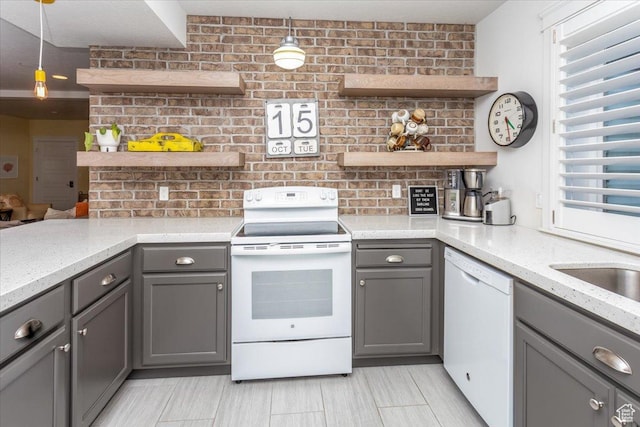 2025 W Orchard Harvest Dr, Kaysville, UT 84037 - kitchen featuring decorative light fixtures, light stone countertops, white appliances, and gray cabinets