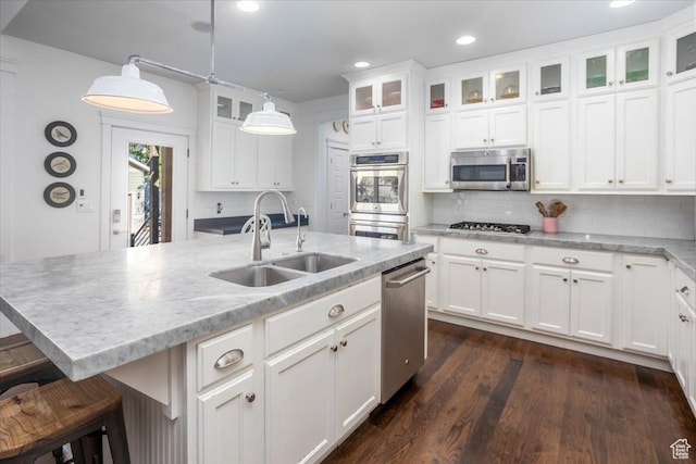 2025 W Orchard Harvest Dr, Kaysville, UT 84037 - kitchen featuring appliances with stainless steel finishes, sink, decorative light fixtures, white cabinetry, and a kitchen island with sink