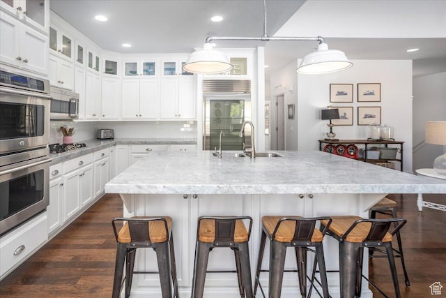 2025 W Orchard Harvest Dr, Kaysville, UT 84037 - kitchen featuring sink, stainless steel appliances, white cabinetry, and a kitchen island with sink