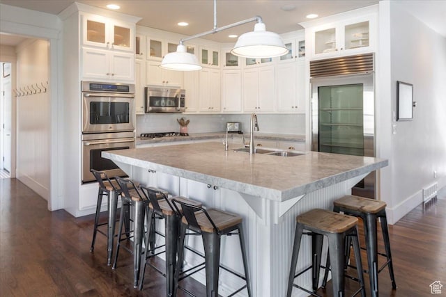 2025 W Orchard Harvest Dr, Kaysville, UT 84037 - kitchen with appliances with stainless steel finishes, sink, white cabinets, a kitchen bar, and an island with sink