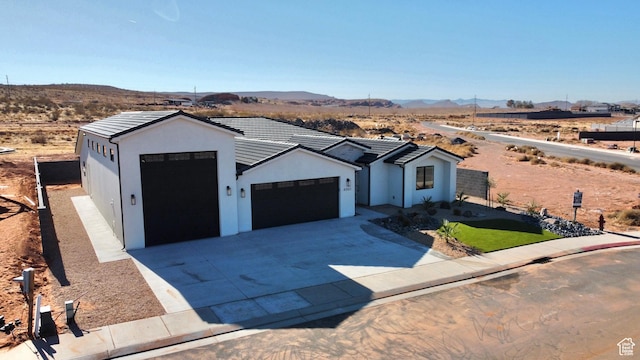 view of front of house with a garage and a mountain view
