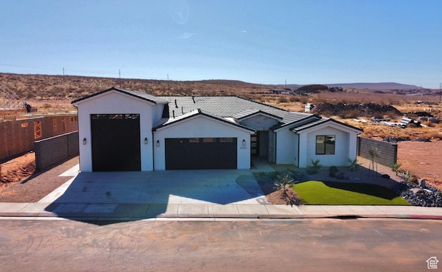 view of front facade with a garage and a mountain view