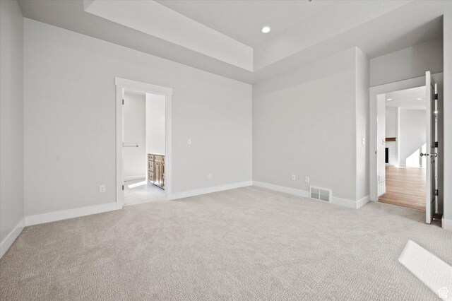 354 S 1150 E Unit 605, Smithfield, UT 84335 - unfurnished bedroom featuring a raised ceiling, recessed lighting, visible vents, and light colored carpet