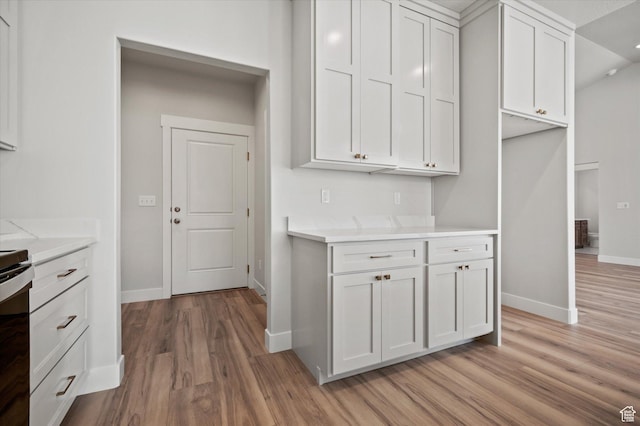 354 S 1150 E Unit 605, Smithfield, UT 84335 - kitchen featuring light countertops, baseboards, white cabinetry, and light wood-style floors