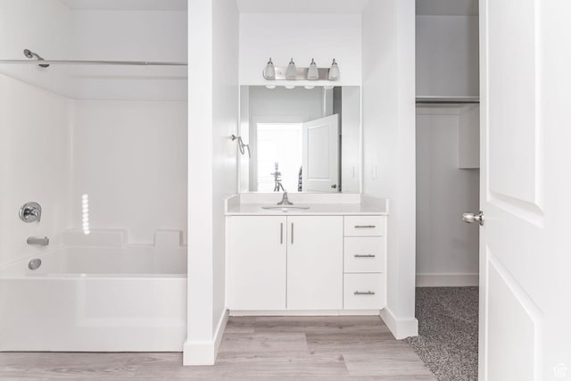 bathroom featuring shower / tub combination and vanity