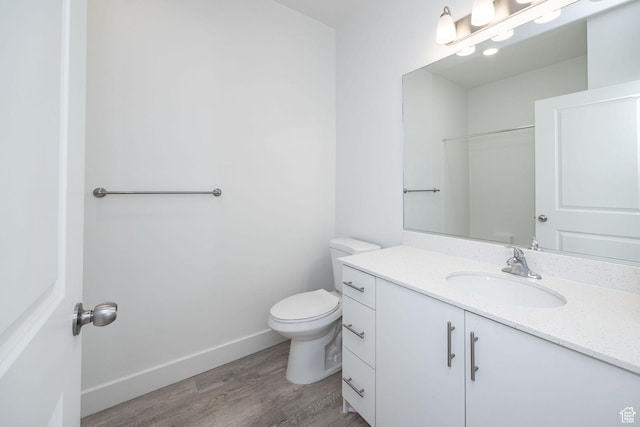 bathroom featuring hardwood / wood-style floors, toilet, and vanity