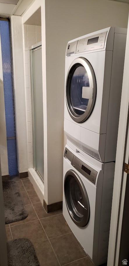 576 E Vine St Unit 2B, Murray, UT 84107 - laundry area with tile patterned floors, stacked washer and clothes dryer, and laundry area