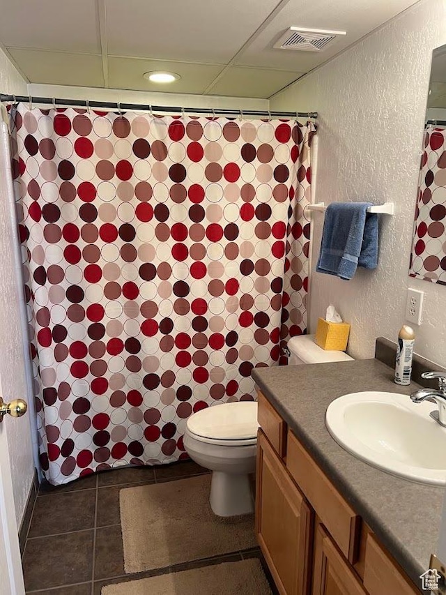 576 E Vine St Unit 2B, Murray, UT 84107 - full bathroom featuring tile patterned floors, visible vents, toilet, vanity, and a textured wall
