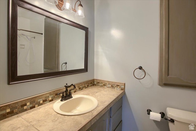 4698 Porter Ave, South Ogden, UT 84403 - bathroom with vanity, toilet, a shower, and tasteful backsplash