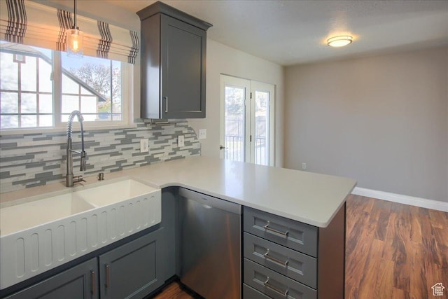 4698 Porter Ave, South Ogden, UT 84403 - kitchen featuring dishwasher, kitchen peninsula, pendant lighting, and tasteful backsplash