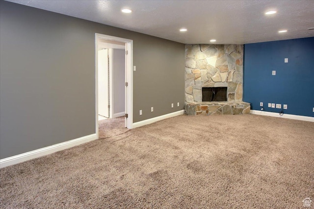 4698 Porter Ave, South Ogden, UT 84403 - unfurnished living room with a stone fireplace, a textured ceiling, and carpet floors