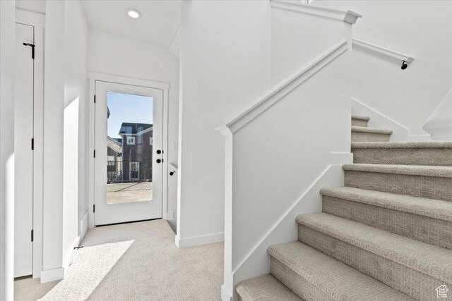 staircase with carpet flooring, baseboards, and recessed lighting