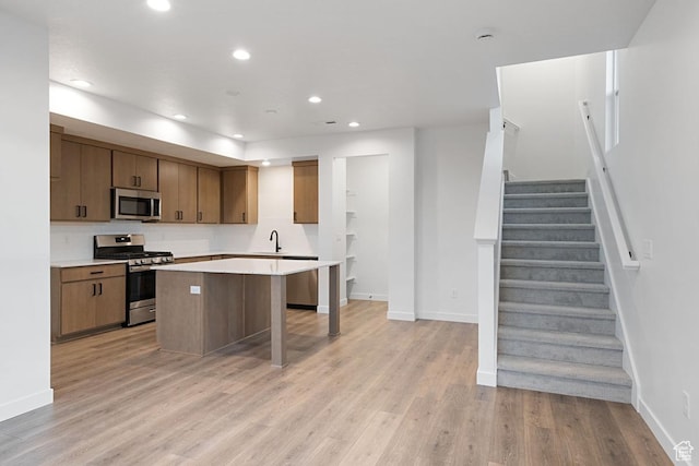 7091 W S Jordan Pkwy Unit 394, South Jordan, UT 84009 - kitchen with appliances with stainless steel finishes, a sink, light wood-type flooring, light countertops, and baseboards