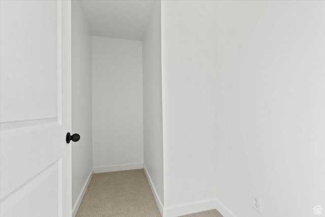 hall with baseboards and carpet flooring