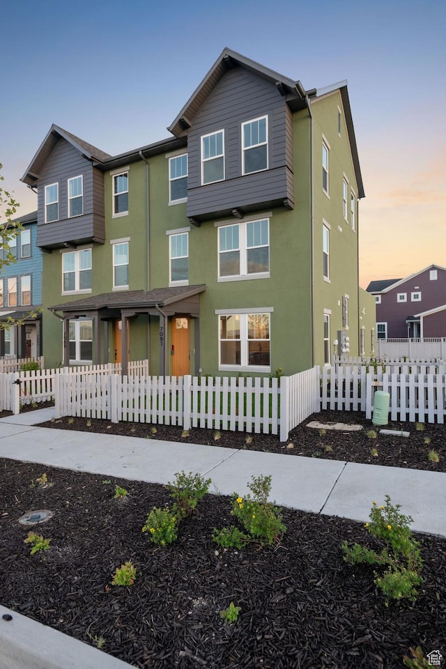 7091 W S Jordan Pkwy Unit 394, South Jordan, UT 84009 - view of front facade with stucco siding and a fenced front yard