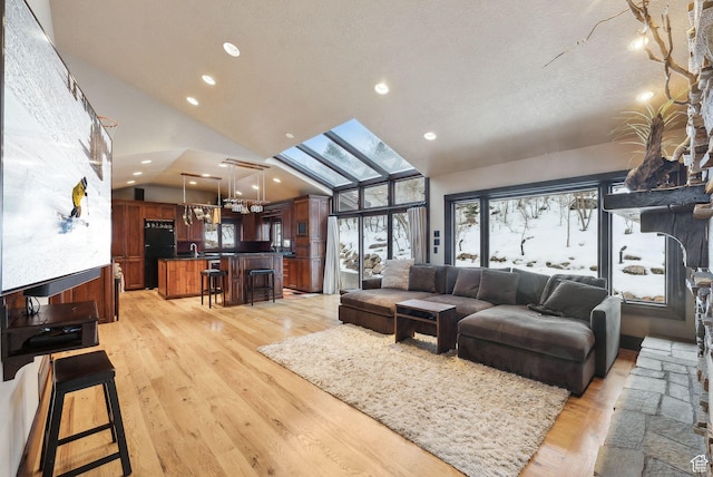4552 S Zarahemla Dr E, Salt Lake City, UT 84124 - living room featuring high vaulted ceiling, recessed lighting, a skylight, light wood finished floors, and a notable chandelier