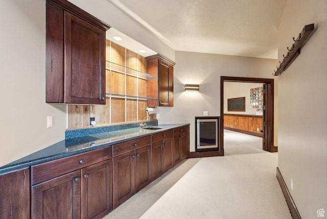 4552 S Zarahemla Dr E, Salt Lake City, UT 84124 - kitchen featuring light colored carpet, a sink, beverage cooler, wainscoting, and wooden walls