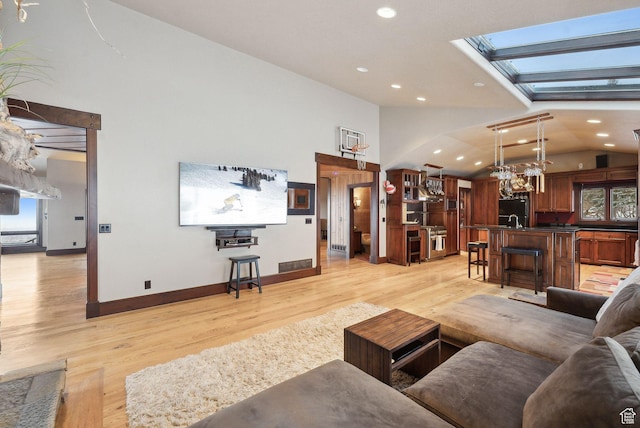 4552 S Zarahemla Dr E, Salt Lake City, UT 84124 - living area featuring a wealth of natural light, light wood finished floors, visible vents, and baseboards