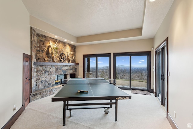 4552 S Zarahemla Dr E, Salt Lake City, UT 84124 - recreation room with a fireplace, baseboards, a textured ceiling, and carpet floors