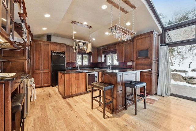 4552 S Zarahemla Dr E, Salt Lake City, UT 84124 - kitchen with a center island, freestanding refrigerator, dark countertops, light wood-style floors, and wine cooler