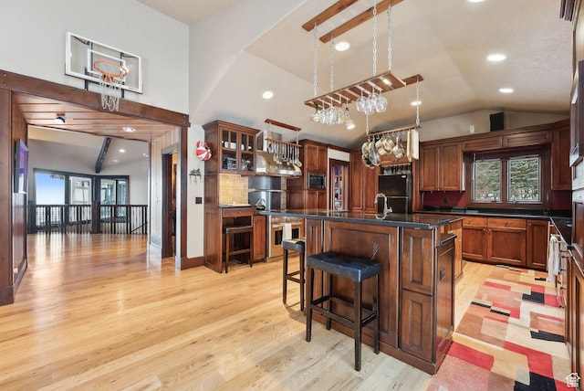 4552 S Zarahemla Dr E, Salt Lake City, UT 84124 - kitchen with dark countertops, freestanding refrigerator, stainless steel microwave, light wood finished floors, and lofted ceiling