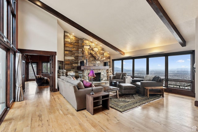 4552 S Zarahemla Dr E, Salt Lake City, UT 84124 - living room with light wood-type flooring, high vaulted ceiling, a stone fireplace, and beam ceiling