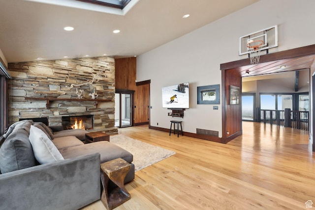 4552 S Zarahemla Dr E, Salt Lake City, UT 84124 - living area with baseboards, a fireplace, recessed lighting, wood finished floors, and high vaulted ceiling