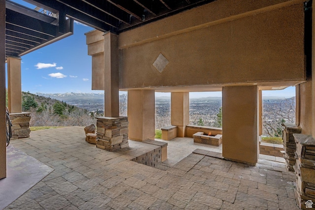 4552 S Zarahemla Dr E, Salt Lake City, UT 84124 - view of patio with an outdoor fire pit and a mountain view