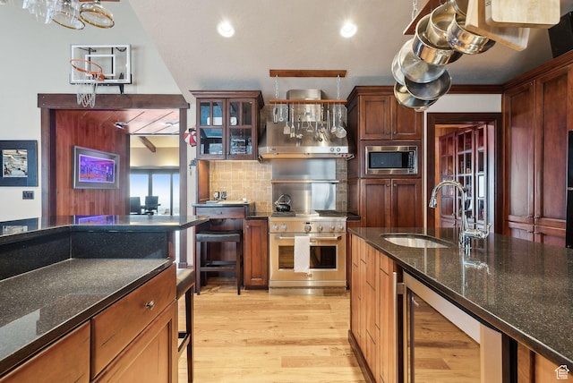 4552 S Zarahemla Dr E, Salt Lake City, UT 84124 - kitchen with a sink, light wood-type flooring, appliances with stainless steel finishes, wine cooler, and backsplash