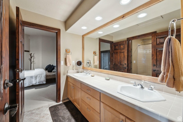 4552 S Zarahemla Dr E, Salt Lake City, UT 84124 - bathroom featuring a sink, tiled shower, double vanity, and recessed lighting