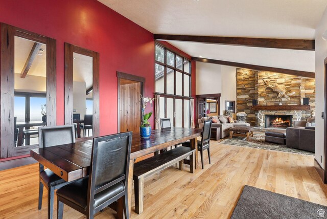 4552 S Zarahemla Dr E, Salt Lake City, UT 84124 - dining area with a fireplace, beamed ceiling, and wood finished floors