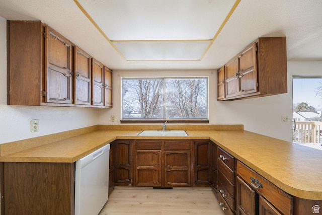 2243 N 1400 E, North Logan, UT 84341 - kitchen featuring white dishwasher, sink, kitchen peninsula, and light hardwood / wood-style floors