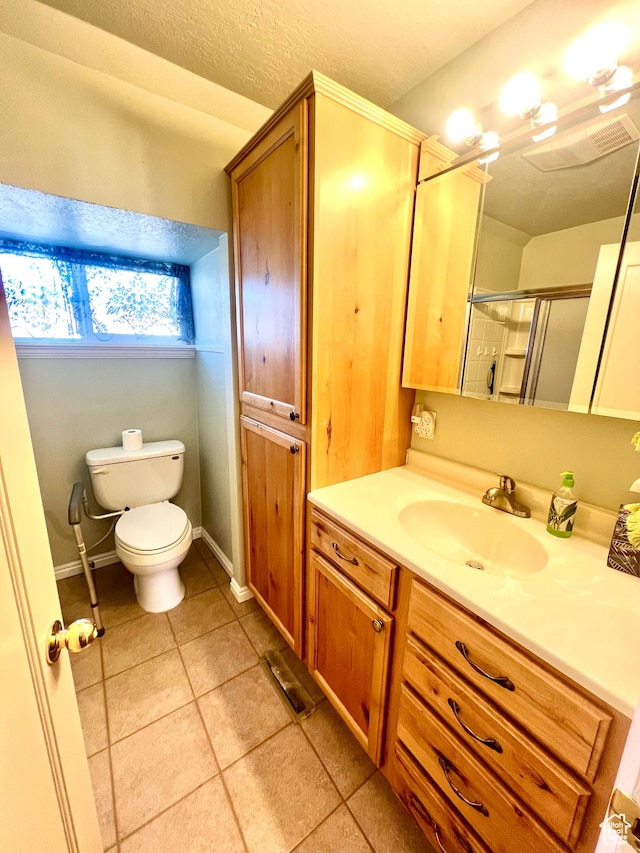 96 W 200 N, Richfield, UT 84701 - bathroom with a textured ceiling, an enclosed shower, tile patterned flooring, vanity, and toilet