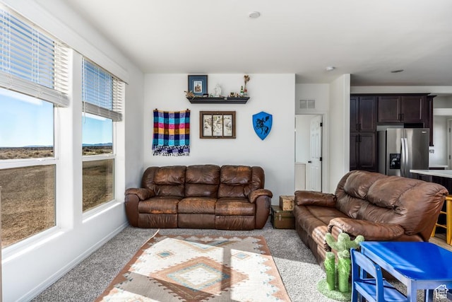 living room with a healthy amount of sunlight and light colored carpet