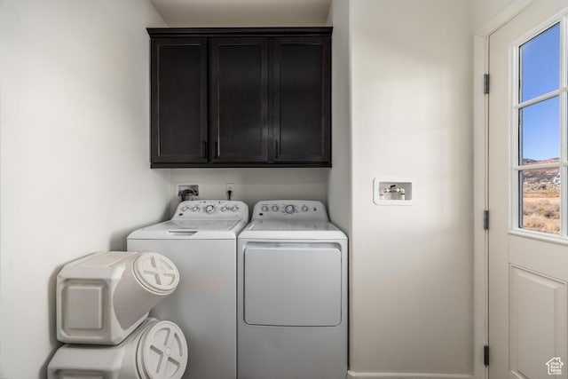 laundry area featuring cabinets and washing machine and clothes dryer