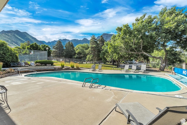 3850 S Quail Hollow Dr E Unit 22, Millcreek, UT 84109 - view of swimming pool featuring a mountain view and a patio