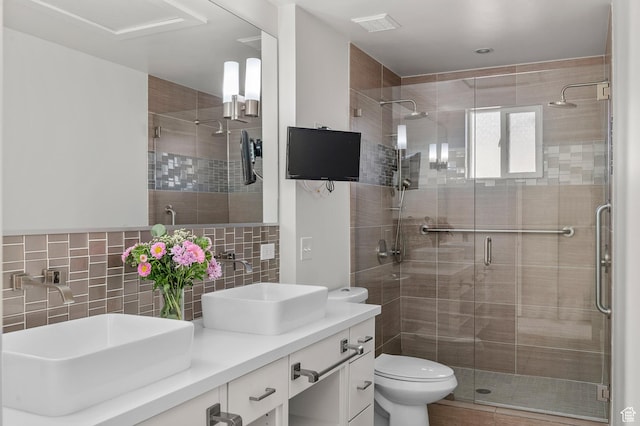 3850 S Quail Hollow Dr E Unit 22, Millcreek, UT 84109 - bathroom featuring a shower with door, tile walls, backsplash, toilet, and vanity