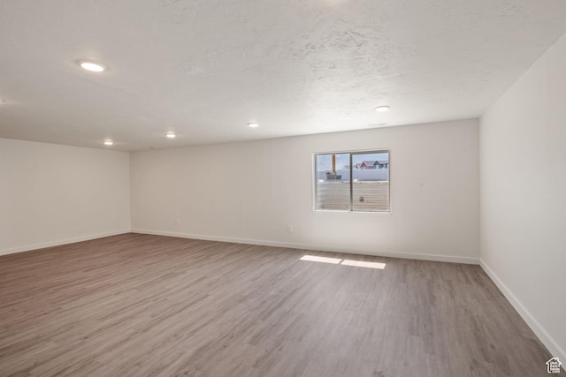 3492 N Delta St, Eagle Mountain, UT 84005 - basement featuring hardwood / wood-style floors and a textured ceiling