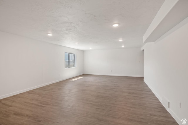 3492 N Delta St, Eagle Mountain, UT 84005 - spare room featuring a textured ceiling and dark hardwood / wood-style flooring