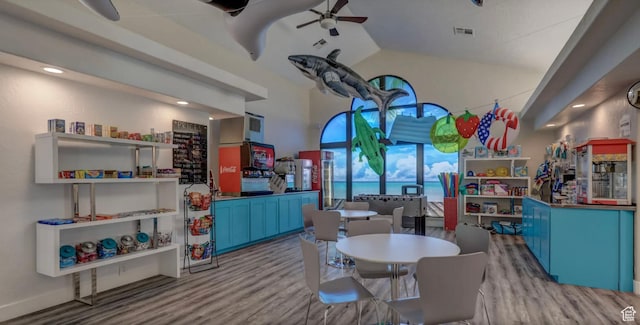 playroom featuring ceiling fan, light wood-type flooring, and vaulted ceiling