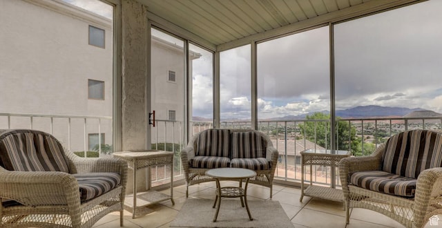 sunroom / solarium featuring a mountain view