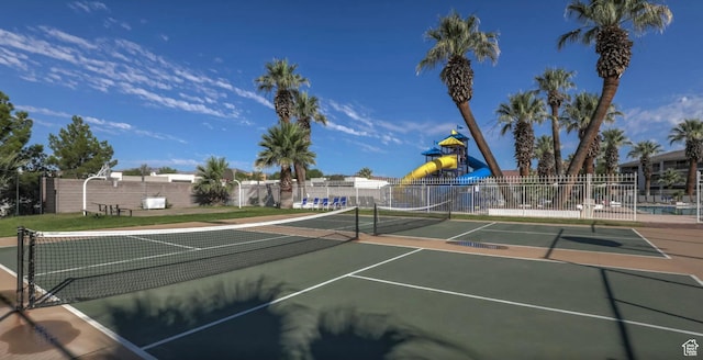 view of sport court featuring a playground and basketball court