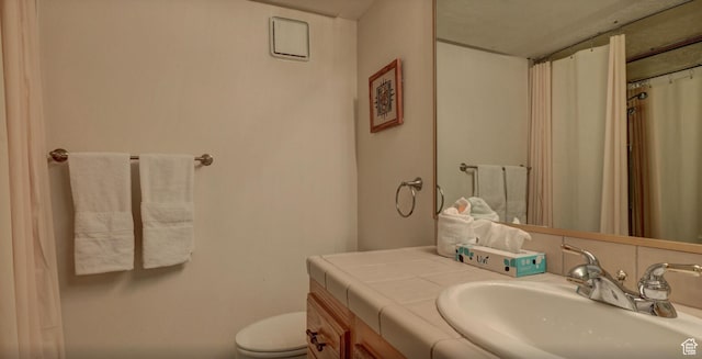 bathroom with toilet and vanity