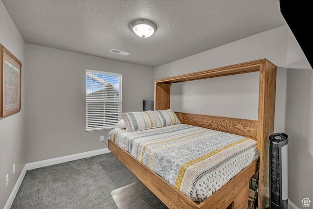 bedroom with a textured ceiling and carpet floors