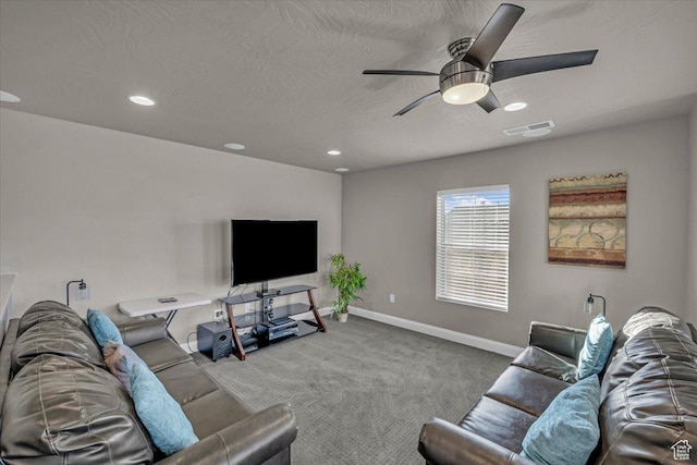 carpeted living room featuring a textured ceiling and ceiling fan