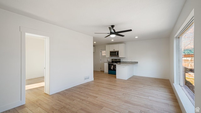 interior space featuring ceiling fan and light wood-type flooring
